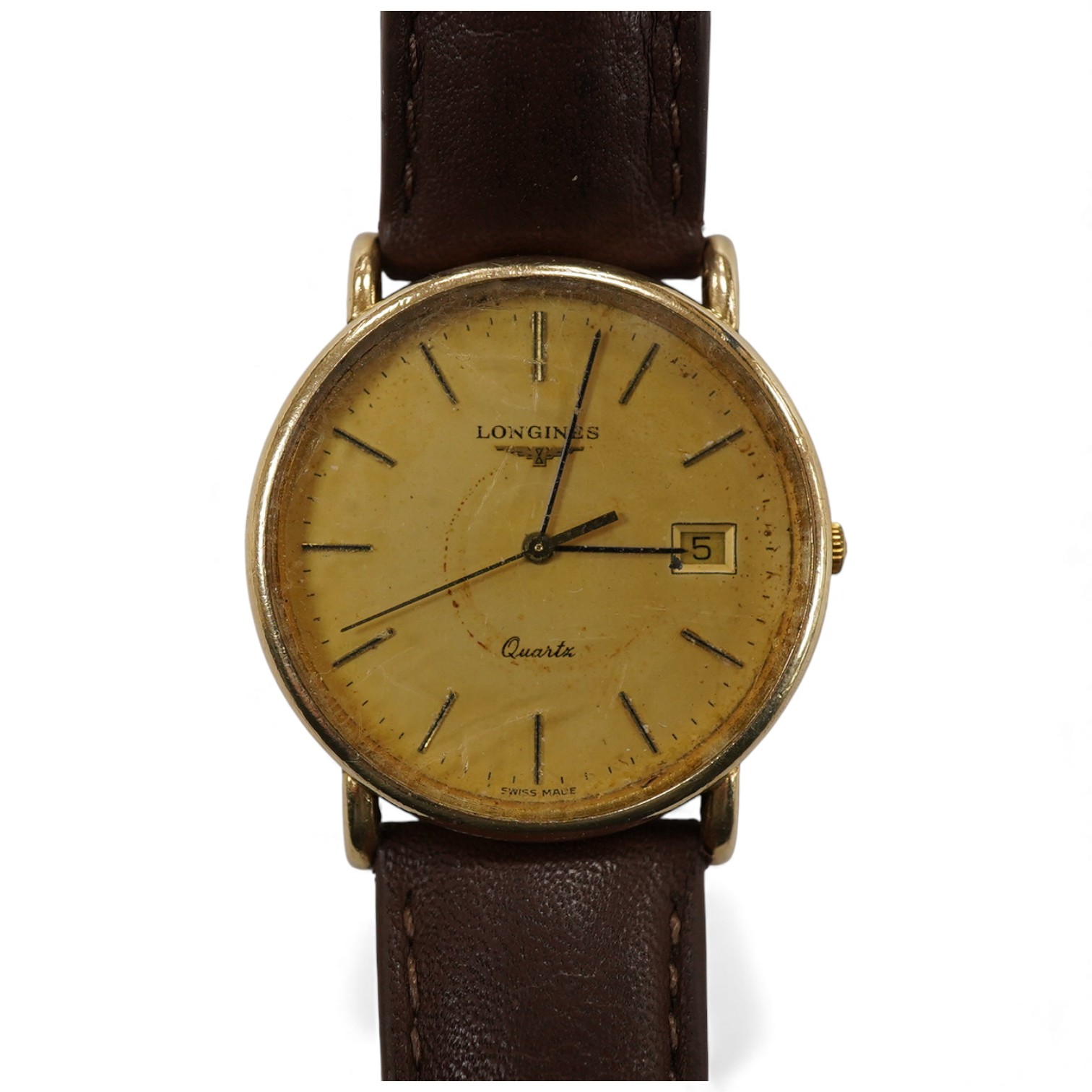 A gentleman's late 20th century Longines 9ct gold quartz wrist watch, with baton numerals and date aperture, the case back with engraved monogram, case diameter 32mm, on an associated leather strap, no box or papers.